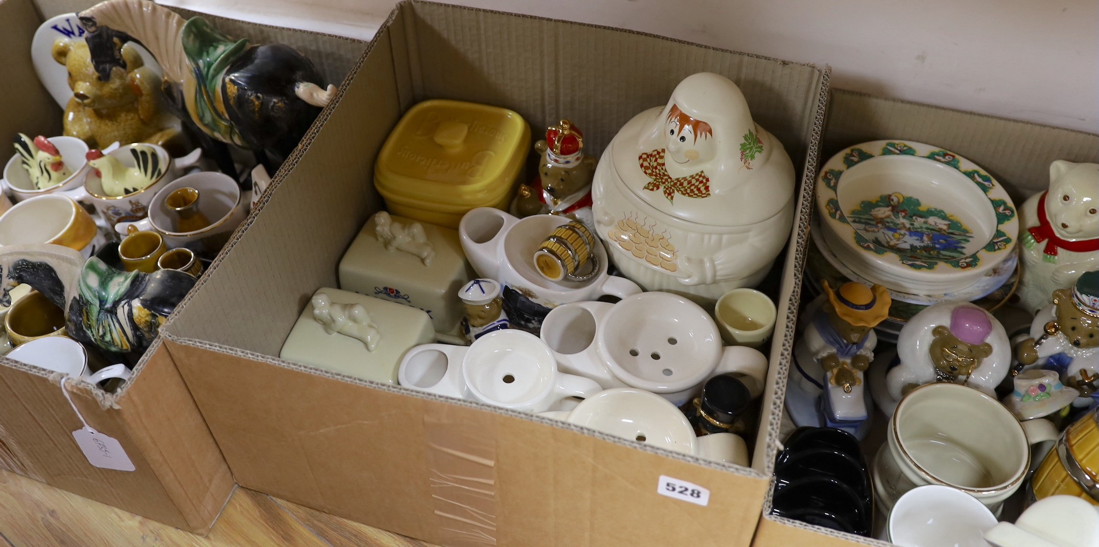 A large quantity of mostly Wade ceramics including some coronation wares, Lurpak butter dishes etc.